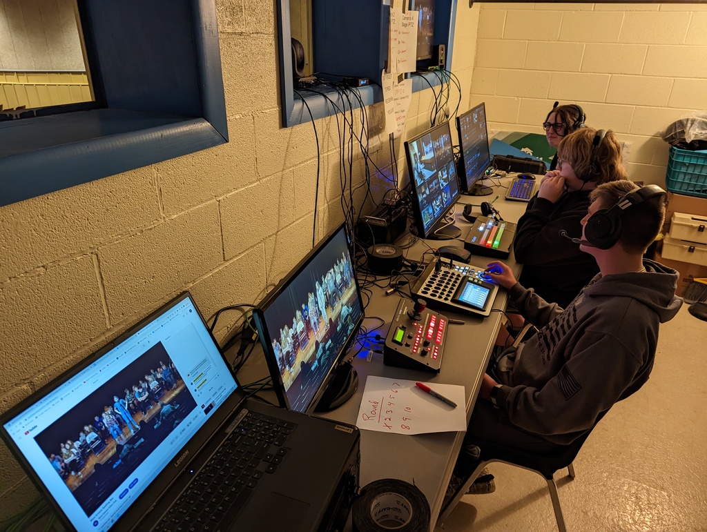 Video Club Members Justin Pettit (Audio & PTZ Camera Operator), William Bell (Switcher), and Elizabeth Bell (Graphics) in the broadcast control room.