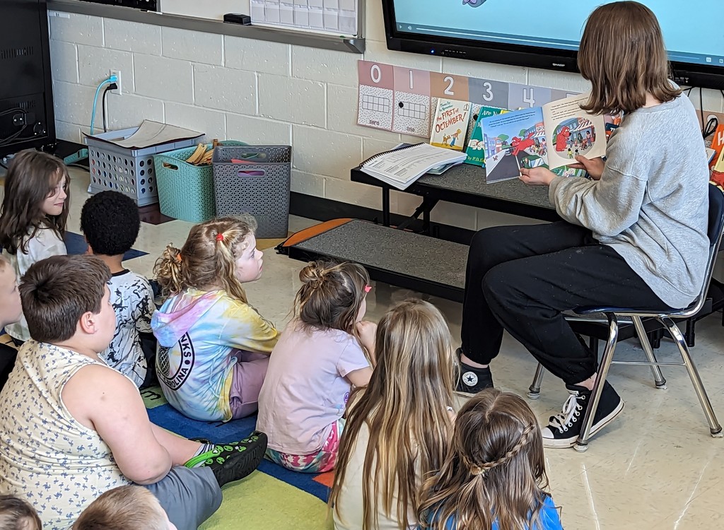 Elizabeth reading to half of the Kindergarten students.